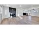 Spacious living area with hardwood floors, fireplace, and kitchen view at 406 Everette Ave, Clayton, NC 27520
