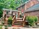 Multi-level wooden deck with lush landscaping and outdoor seating, ideal for entertaining at 4139 Somerset Dr, Oxford, NC 27565