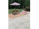 Inviting backyard picnic area with a picnic table, umbrella and stepping stones at 4139 Somerset Dr, Oxford, NC 27565
