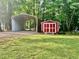 View of backyard featuring open metal carport and painted storage shed at 4139 Somerset Dr, Oxford, NC 27565