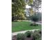 Expansive backyard with lush greenery, mature trees, and a peaceful setting at 4139 Somerset Dr, Oxford, NC 27565