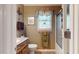 Well-lit bathroom features a vanity, toilet, and a shower with glass doors at 4139 Somerset Dr, Oxford, NC 27565