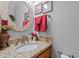 Granite top vanity with decorative mirror and sink in a neutral-colored bathroom at 4139 Somerset Dr, Oxford, NC 27565