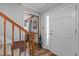 Bright entryway with hardwood floors and wooden staircase at 4139 Somerset Dr, Oxford, NC 27565