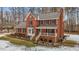 Brick two-story house with a white porch, landscaping, and snowy yard at 4139 Somerset Dr, Oxford, NC 27565