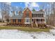 Brick two-story house with a snow covered front yard at 4139 Somerset Dr, Oxford, NC 27565