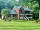 Charming two-story brick home with a landscaped front yard and inviting front porch at 4139 Somerset Dr, Oxford, NC 27565
