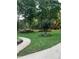 Landscaped front yard with green grass and flowering plants at 4139 Somerset Dr, Oxford, NC 27565