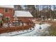 Brick house with large deck and snowy yard at 4139 Somerset Dr, Oxford, NC 27565