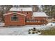 Rear view of brick house featuring a large deck, chimney, and well-maintained yard at 4139 Somerset Dr, Oxford, NC 27565