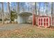 Red storage shed and metal carport in backyard setting at 4139 Somerset Dr, Oxford, NC 27565