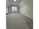 A sunlit, carpeted bedroom features neutral walls, recessed lighting and views through the large window at 504 Tucker St, Four Oaks, NC 27524