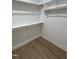 A well-organized closet with wooden rods and shelves for optimal storage and light hardwood flooring at 504 Tucker St, Four Oaks, NC 27524