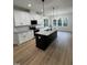 Bright kitchen featuring white cabinets, granite countertops, and black appliances at 504 Tucker St, Four Oaks, NC 27524