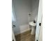 Modern powder room with pedestal sink and hardwood floors at 504 Tucker St, Four Oaks, NC 27524
