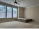Spacious bedroom with a ceiling fan and large windows at 549 Balsam Fir Dr Dr, Cary, NC 27519