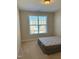 Spacious bedroom with large window and carpeted floor at 549 Balsam Fir Dr Dr, Cary, NC 27519