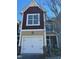 Townhome exterior features a white garage door, and a mix of tan and burgundy siding at 549 Balsam Fir Dr Dr, Cary, NC 27519