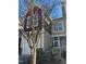 Tan and burgundy exterior of townhome with white garage door and landscaping at 549 Balsam Fir Dr Dr, Cary, NC 27519