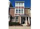 Three-story brick townhome, featuring a front door and landscaping at 549 Balsam Fir Dr Dr, Cary, NC 27519