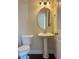 Simple half bathroom with pedestal sink and oval mirror at 549 Balsam Fir Dr Dr, Cary, NC 27519