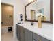 Bathroom with gray vanity and large mirror at 64 W Beech Slope Ct, Chapel Hill, NC 27517