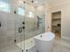 Spa-like bathroom with a freestanding tub and glass shower at 64 W Beech Slope Ct, Chapel Hill, NC 27517