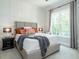Bright bedroom with large window and plush bedding at 64 W Beech Slope Ct, Chapel Hill, NC 27517