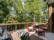Deck with seating and dining areas overlooking the woods at 64 W Beech Slope Ct, Chapel Hill, NC 27517