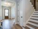 Bright entryway with hardwood floors, stairs, and a coat closet at 64 W Beech Slope Ct, Chapel Hill, NC 27517