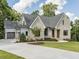Brick house with a two-car garage and manicured lawn at 64 W Beech Slope Ct, Chapel Hill, NC 27517