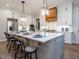 Modern kitchen with white cabinets, large island, and breakfast bar at 64 W Beech Slope Ct, Chapel Hill, NC 27517