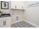 Laundry room with white cabinets and patterned floor at 64 W Beech Slope Ct, Chapel Hill, NC 27517