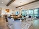 Spacious living room with hardwood floors, exposed beams, and a large window at 64 W Beech Slope Ct, Chapel Hill, NC 27517