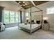 Luxurious main bedroom with a high ceiling and a metal framed bed at 64 W Beech Slope Ct, Chapel Hill, NC 27517