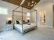 Main bedroom with a large bed, high ceilings, and ensuite bathroom at 64 W Beech Slope Ct, Chapel Hill, NC 27517