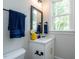 Small bathroom with a white vanity, mirror, and a window at 64 W Beech Slope Ct, Chapel Hill, NC 27517