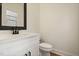 Stylish powder room with white vanity, black matte faucet, and white toilet at 649 Mcadams Rd, Hillsborough, NC 27278