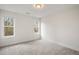 Well-lit bedroom featuring carpet and large windows at 649 Mcadams Rd, Hillsborough, NC 27278