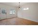 Light-filled dining room with hardwood floors and chandelier at 649 Mcadams Rd, Hillsborough, NC 27278