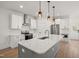 Modern kitchen with white cabinets and gray island at 649 Mcadams Rd, Hillsborough, NC 27278