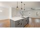 Modern kitchen with gray island and stainless steel appliances at 649 Mcadams Rd, Hillsborough, NC 27278