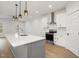 Modern kitchen with white cabinets and gray island at 649 Mcadams Rd, Hillsborough, NC 27278