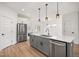 Modern kitchen with gray island and stainless steel appliances at 649 Mcadams Rd, Hillsborough, NC 27278