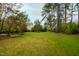 Large backyard with lush greenery and privacy at 715 Powell Dr, Raleigh, NC 27606