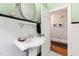 Classic bathroom with pedestal sink and white tile at 715 Powell Dr, Raleigh, NC 27606