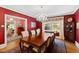 Elegant dining room with hardwood floors, chandelier, and rich red walls at 715 Powell Dr, Raleigh, NC 27606