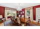 Formal dining room features hardwood floors, chandelier, and window views at 715 Powell Dr, Raleigh, NC 27606