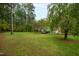 Spacious grassy yard with mature trees, offering ample outdoor space at 715 Powell Dr, Raleigh, NC 27606