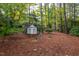 White weather vane in a wooded garden setting at 715 Powell Dr, Raleigh, NC 27606